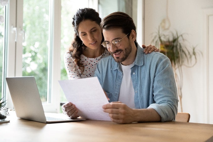 Man and woman reading a document together