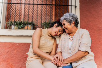 Young woman putting her head on the shoulder of an older woman